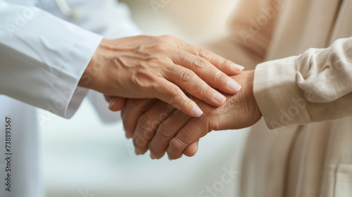close-up of a younger person's hands gently holding the hands of an elderly person, conveying a sense of care and support.