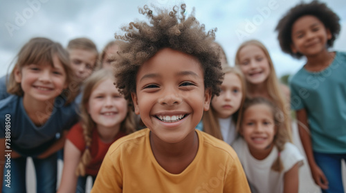 Group of diverse cheerful fun happy multiethnic children outdoors at the schoolyard.