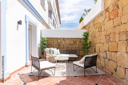 an image of garden furniture surrounded by stoned wall patio in luxury mediterranean villa 