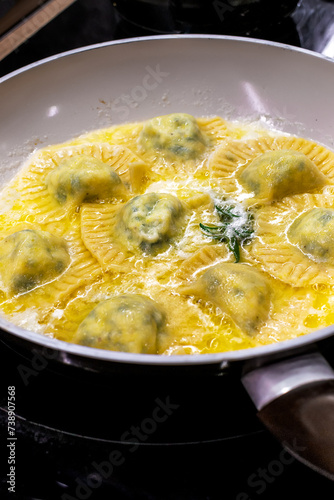Mixing homemade ravioli pasta with cow butter sauce
