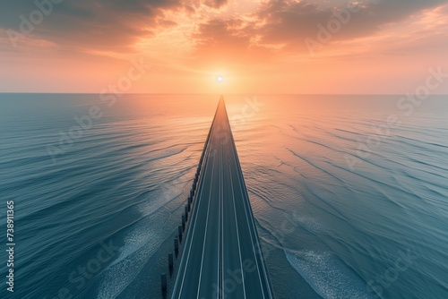 A highway stretching across the sea, leading to a magnificent sunrise that paints the sky in hues of orange and pink, with the gentle sea waves mirroring the sky's colors.