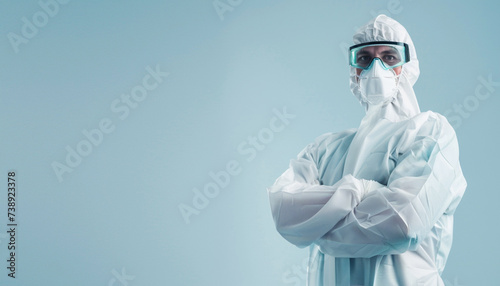 Worker wears medical protective suit or white coverall suit with mask and goggles arm crossed. Copy space image. Place for adding text