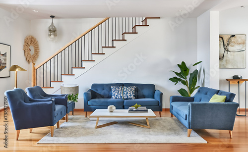 Blue sofas in room with staircase. Scandinavian home interior design of modern living room. photo