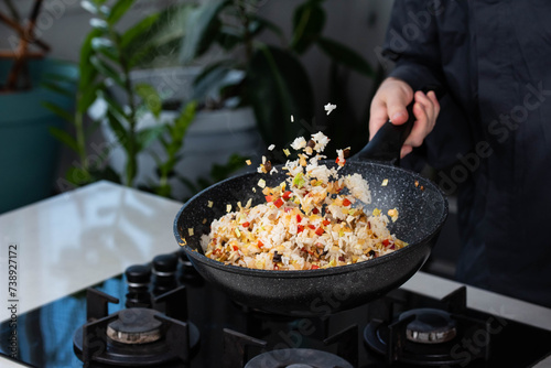 Εκτύπωση καμβά Close up of Chef cook hands cooking and toss roasted vegetables with rice for Asian cuisine in frying wok pan on gas stove