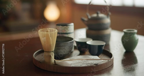 Teapot, herbs and green tea for japanese ceremony, drink and detox for spiritual heritage in home. Wellness, culture or ancient tradition in tokyo for herbal beverage, relax or health matcha in cups photo