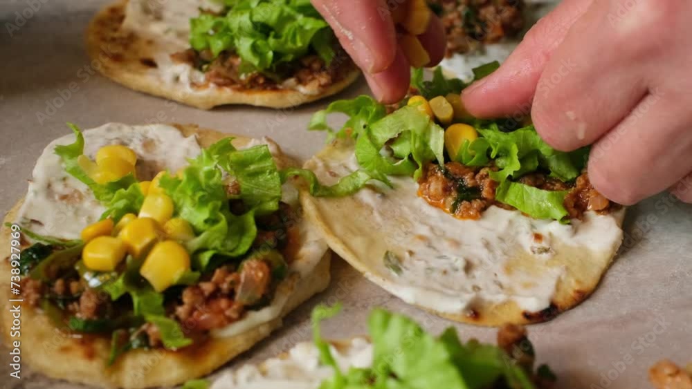 Rolling out taco dough and filling it with foods such as chicken, meat and fish on the gray table Rolling out taco dough and filling it with foods such as chicken, meat and fish on the gray table
