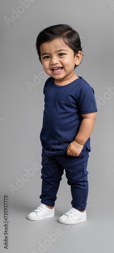 A young and cute toddler wearing a blank plain t-shirt in a studio photo, perfect for mockups or designing custom shirts as templates