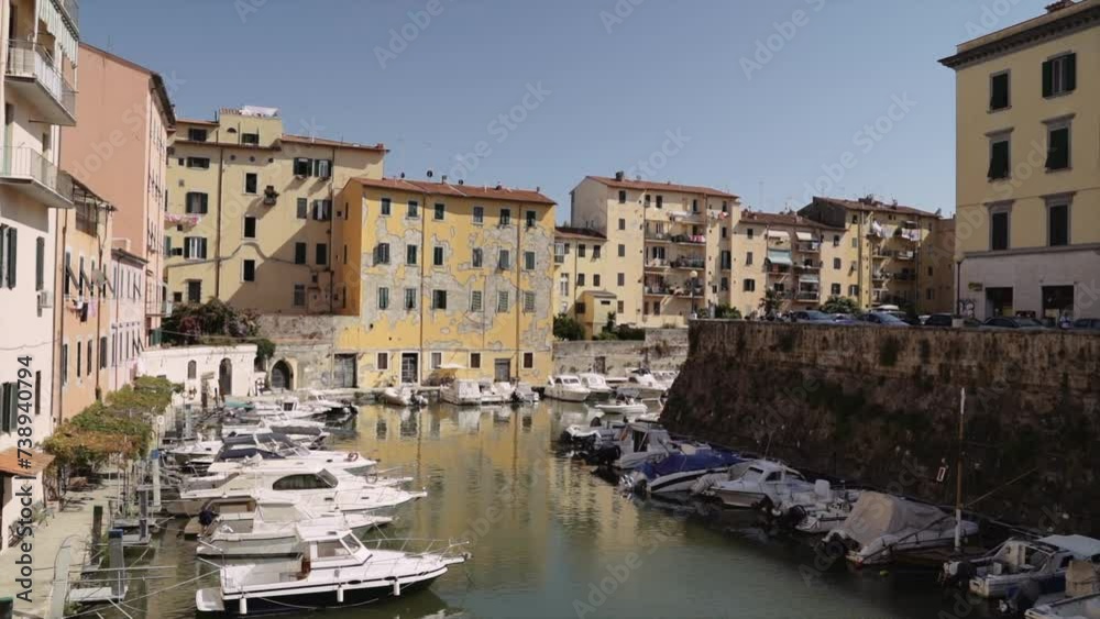 Sailboats Moored On Canal By Old Residential Buildings In Livorno Sailboats Moored On Canal By Old Residential Buildings In Livorno