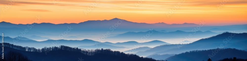 Great Smoky Mountain Ridge at Sunset with Blue and Orange Hues in Foggy Country Setting Great Smoky Mountain Ridge at Sunset with Blue and Orange Hues in Foggy Country Setting