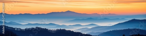 Great Smoky Mountain Ridge at Sunset with Blue and Orange Hues in Foggy Country Setting © Web