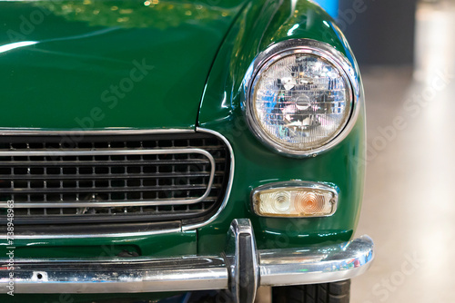 Headlight of an oldtimer green car