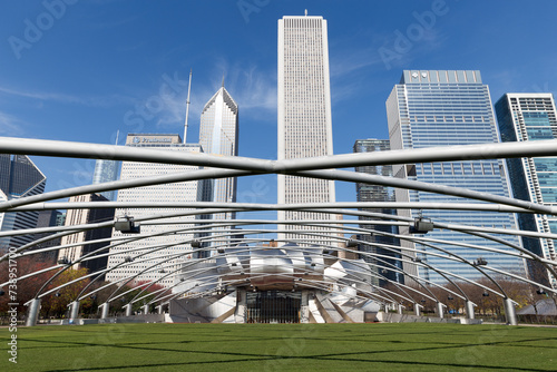 famous entrance of the millenium park in the center of Chicago city with the skyline of downtown photo