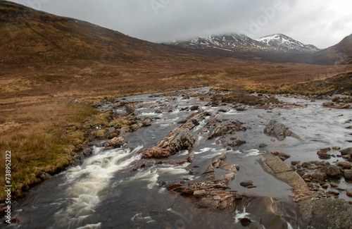 Fotografie Slow shutter release of a fast flowing river in the highlands of Scotland