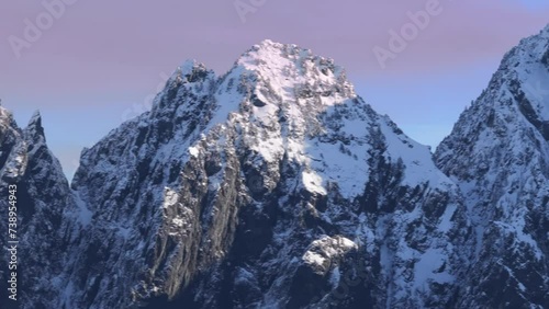 Aerial drone view of winter panorama copy background. Outdoor adventure in snow capped summit. Epic views of North Cascades Mountains at scenic pink sunset. Dramatic mountain landscape of snowy peaks photo