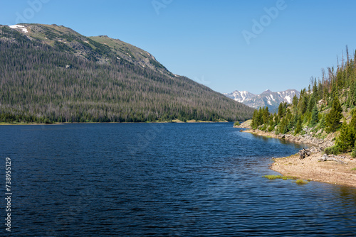 Early Summer morning looking south of Long Draw Reservoir. The backdrop of the dramatic Never Summer Mountain Range is located in Rocky Mountain National Park, Colorado. 