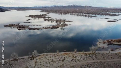 : Drone flight over Lahontan reservoir beautiful reflections and flocks of birds in the air and water. photo