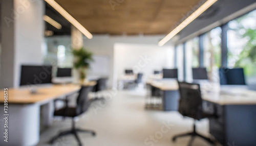 Blurred office interior space background. Blurred interior of modern office workplace a workspace design without partition decorate with black, white and wooden furniture