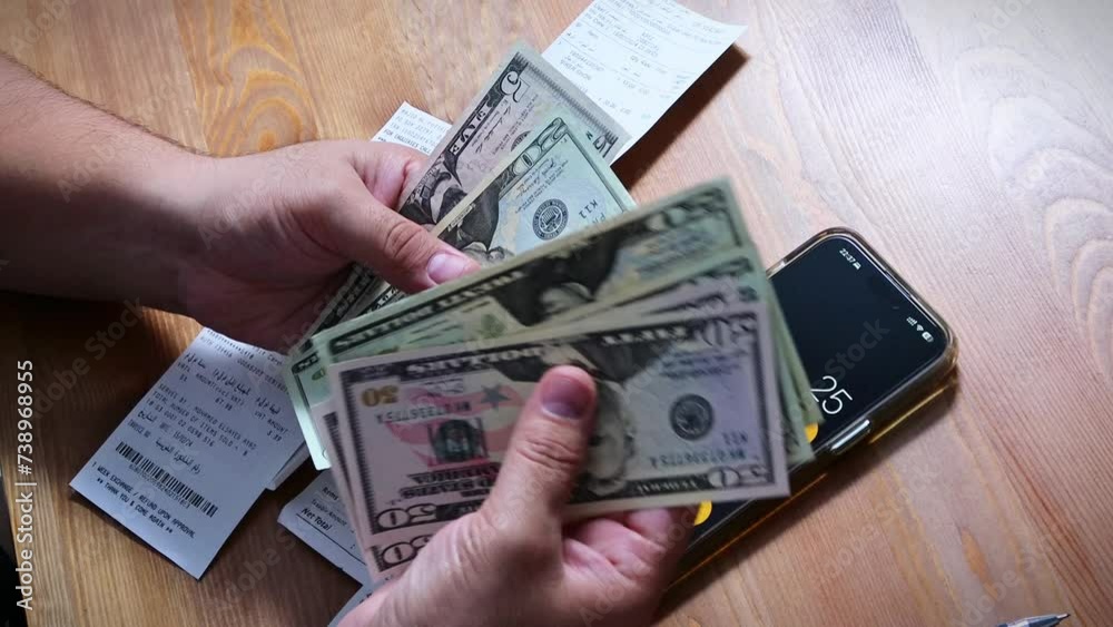 Using their gadget, the person gestured with their thumb and fingers to input numbers into the font on the calculator to calculate bills Using their gadget, the person gestured with their thumb and fingers to input numbers into the font on the calculator to calculate bills