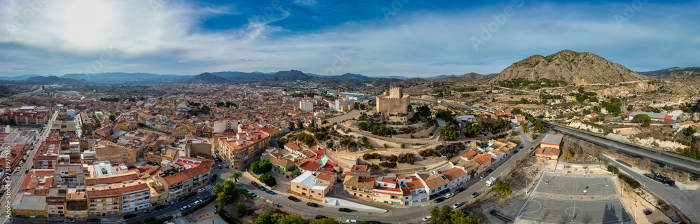 Aerial view of Petrer, medieval town and hilltop castle with restored tower and battlements near Elda Spain,