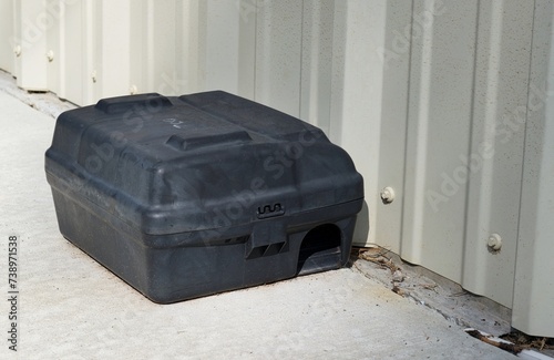 Φωτογραφία Rat bait station by a wall outdoors, front low angle view