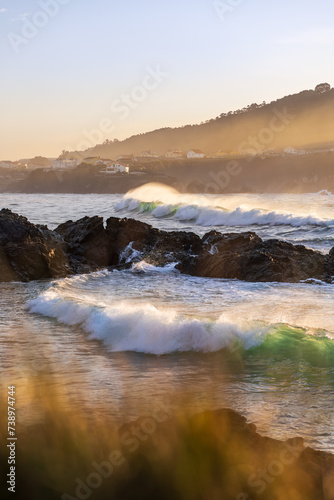 Waves breaking on the sea near the beach at sunset. Meiras, Galicia, Spain.