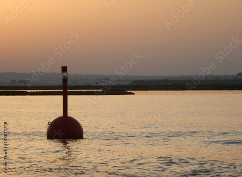Red signaling buoy in the sea