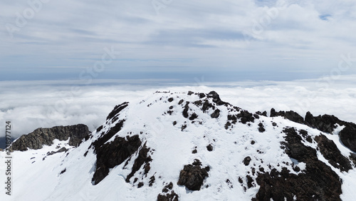 A mountain covered with snow in New Zealand, the horizon in the background with clouds