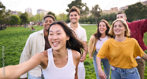 Selfie of a happy group of students having fun. Confident millennial friends gathering. Young people celebrating success while run a race outdoors on grass. Friendship, youth culture and freedom