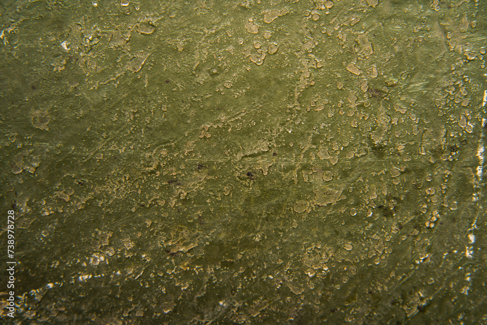A detailed close-up view of a dirty and grungy surface, showing the texture and layers of grime accumulated.