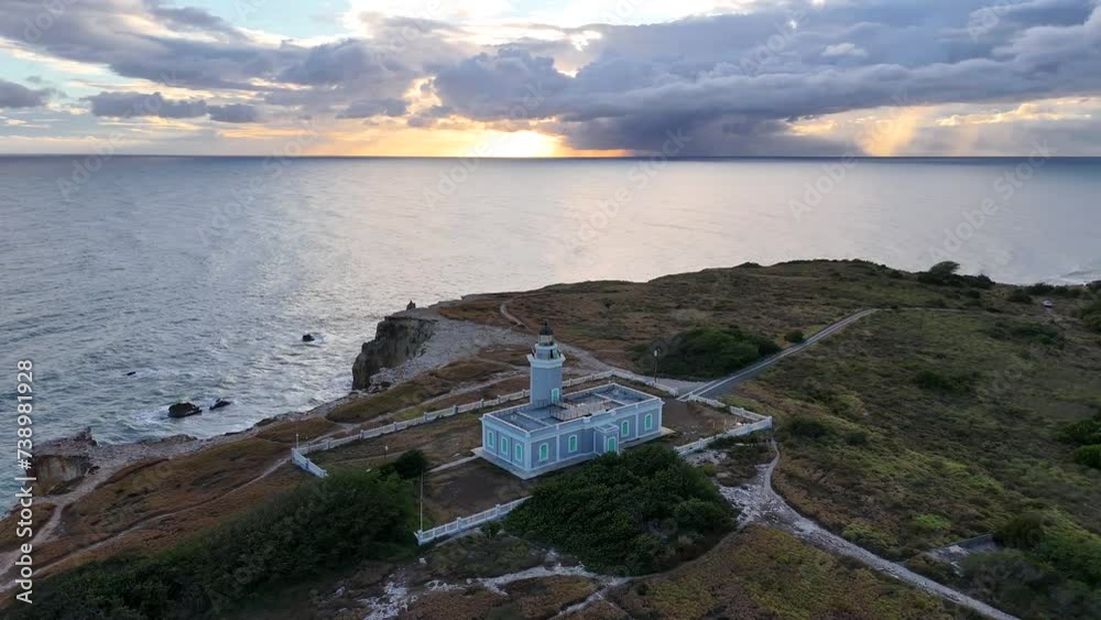 Lone lighthouse overlooking cliff on Caribbean island. Aerial drone footage of Cabo Rojo lighthouse in Puerto Rico. 