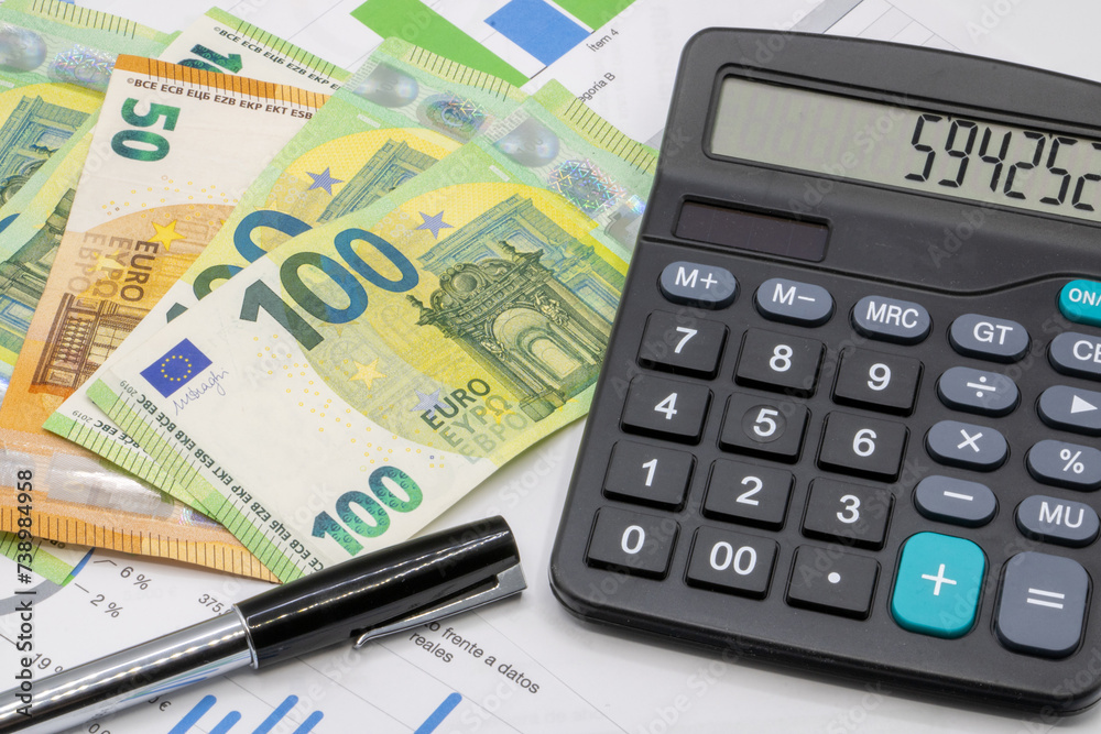 Calculator on finance graphs and euro bills Calculator on finance graphs and euro bills