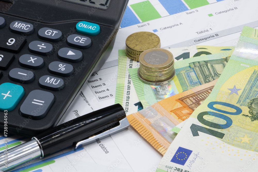 Calculator on finance graphs and euro bills Calculator on finance graphs and euro bills