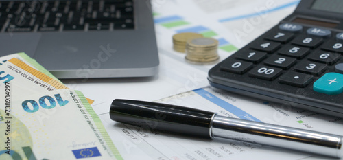 Calculator on finance graphs and euro bills
