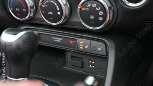 Pressing the heated seat button in a car