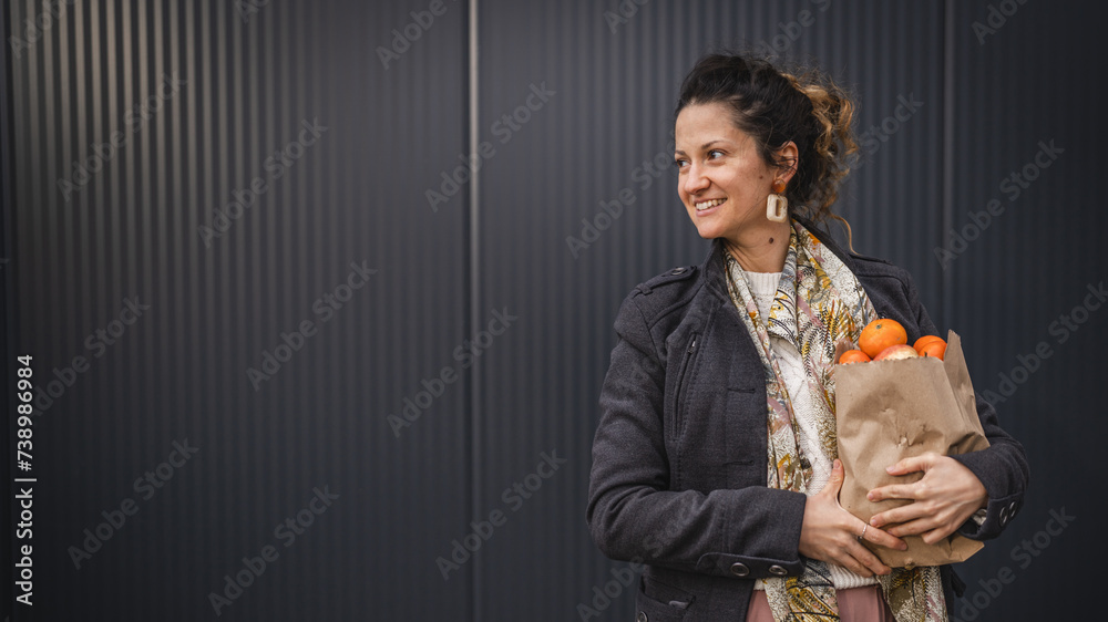 Portrait of one woman hold organic fruit and vegetables in paper bag Portrait of one woman hold organic fruit and vegetables in paper bag