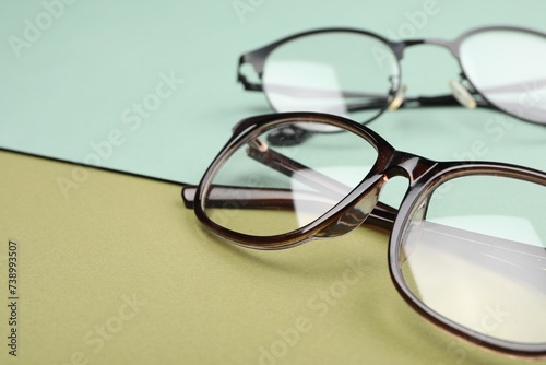 Glasses on color background, closeup. Space for text