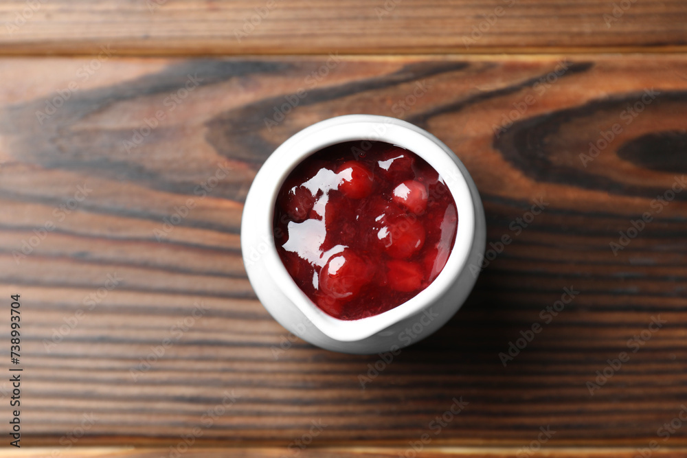 Fresh cranberry sauce in pitcher on wooden table, top view Fresh cranberry sauce in pitcher on wooden table, top view