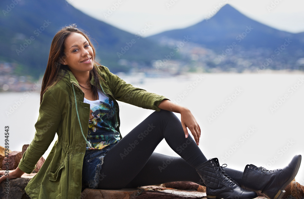 Portrait, woman and smile for sitting with mountain and sea on vacation, holiday or roadtrip. Female person, tourist or traveler with calm, joy and happiness while relaxing in Cape Town, South Africa Portrait, woman and smile for sitting with mountain and sea on vacation, holiday or roadtrip. Female person, tourist or traveler with calm, joy and happiness while relaxing in Cape Town, South Africa