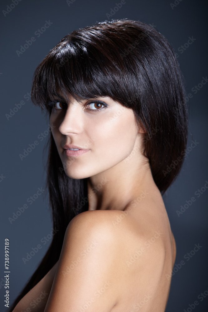 Fototapeta premium Beauty, skincare and portrait of woman with confident skin glow, natural makeup and facial care in studio. Pride, dermatology and luxury cosmetics with face of girl isolated on dark blue background.