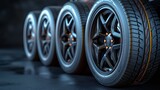 A series of high-performance car tires aligned on a dark, textured surface, showcasing modern automotive design.