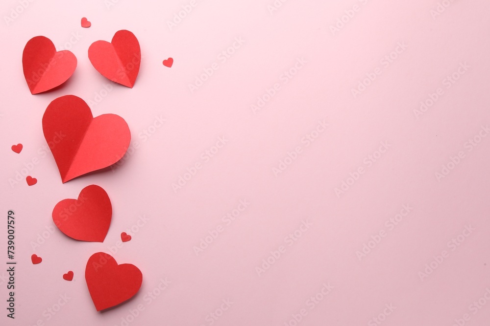 Paper hearts on pink background, flat lay. Space for text