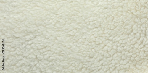 Texture of white fleece fabric as background, top view