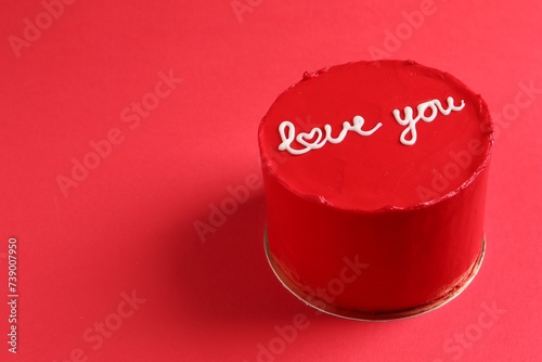 Bento cake with text Love You on red table, space for text. St. Valentine's day surprise
