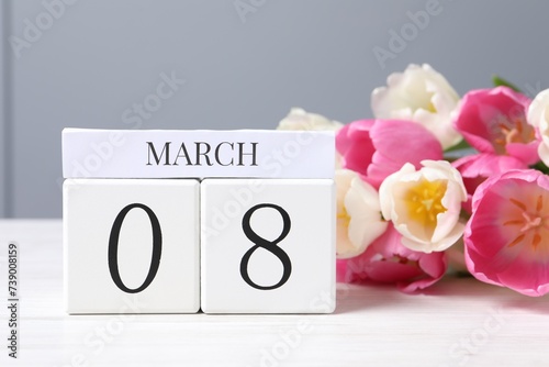 Wallpaper Mural International Women's day - 8th of March. Wooden block calendar and beautiful flowers on white table Torontodigital.ca