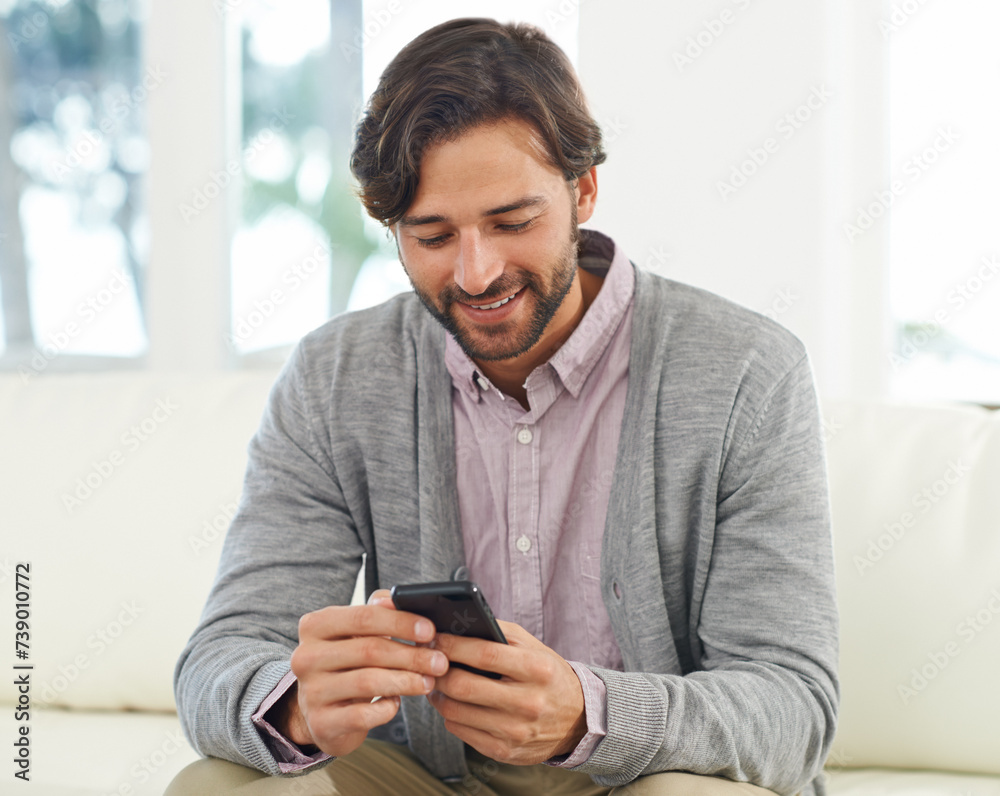 Man, relax and smile on sofa with smartphone for internet browsing, communication and texting for connection. Male person, comfortable and couch with cellphone for scroll social media in living room Man, relax and smile on sofa with smartphone for internet browsing, communication and texting for connection. Male person, comfortable and couch with cellphone for scroll social media in living room