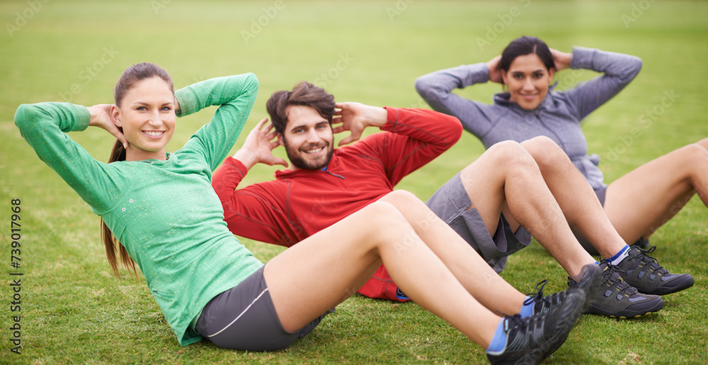 Fototapeta premium Friends, sit ups and fitness on field for portrait, training or happy for abdomen exercise in summer. People, man and women with wellness with smile, core workout and group on grass lawn in Australia