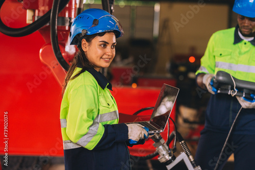 Young female engineers, experts in computer maintenance, are used to create work systems in warehouses and factories. They work together