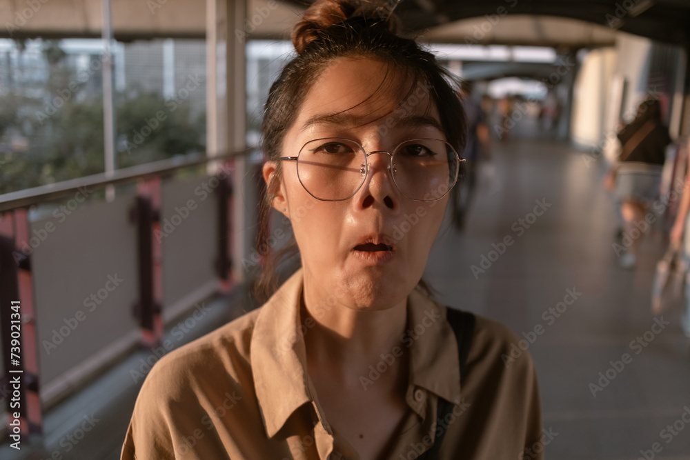 Close up of Asian woman make funny hilarious face to the camera. Close up of Asian woman make funny hilarious face to the camera.