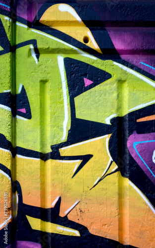 Colorful background of graffiti painting artwork with bright aerosol outlines on wall. Old school street art piece made with aerosol spray paint cans. Contemporary youth culture backdrop