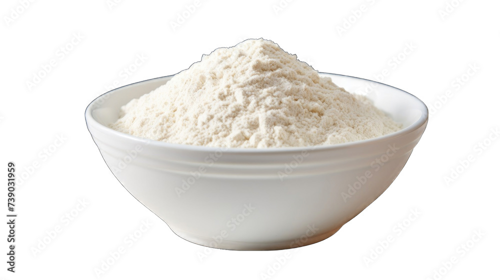 A bowl filled with flour sits on a table, with a pile of flour next to it png